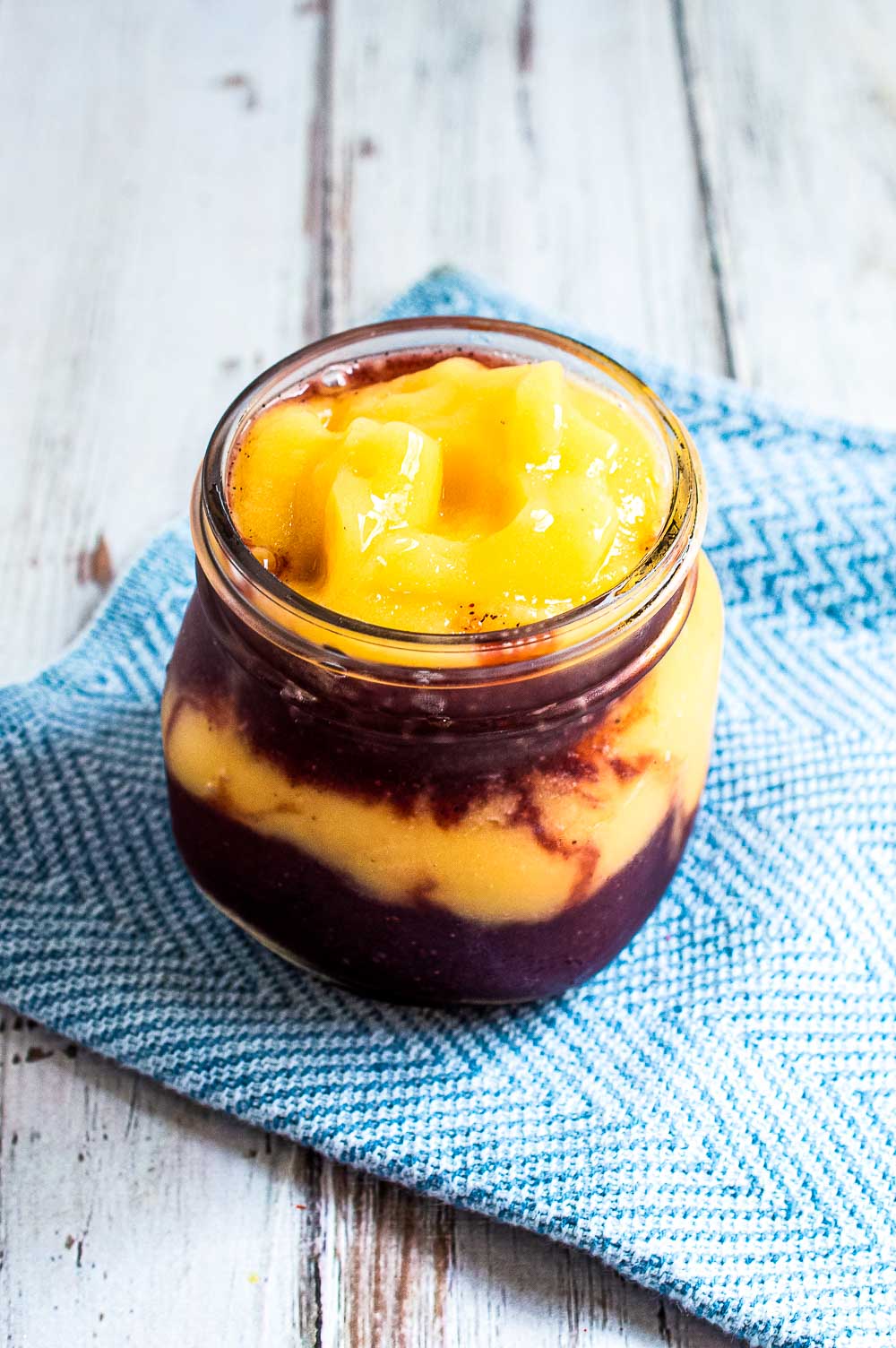 Blueberry Peach Smoothie or Blueberry Peach Slushies. No matter how you call this, it is a perfect way to beat the summer heat! This delicious blueberry and peach smoothie is a pretty, refreshing and energizing way to start the day!