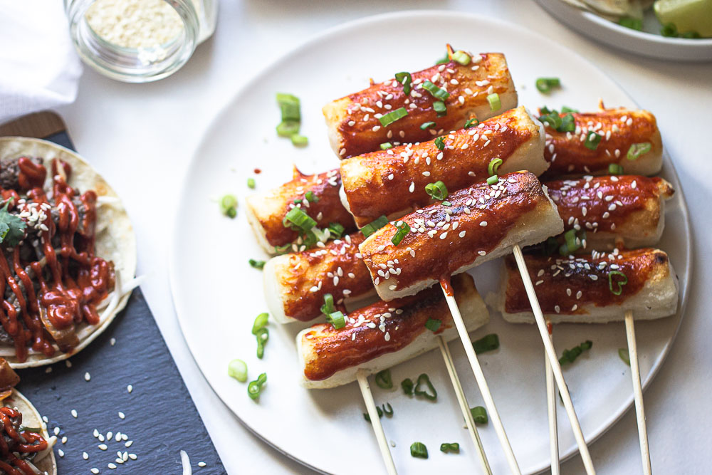 This grilled tteokbokki is a popular Korean street food that comes in the form of a sweet and chewy rice cake. A delicious Asian sauce soaks these rice cakes (or more appropriately, rolls) once they’ve been grilled to perfection. These spicy, Korean rice cakes are usually about the size of a thumb and have the perfect light crisp on the outside with a delightfully chewy center.