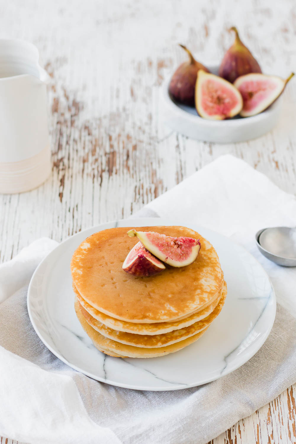 Easy Fluffy Fig Pancakes. So incredibly fluffy, tender and crisp in all the right places with a pile of fresh fruit and maple syrup for the ultimate breakfast.