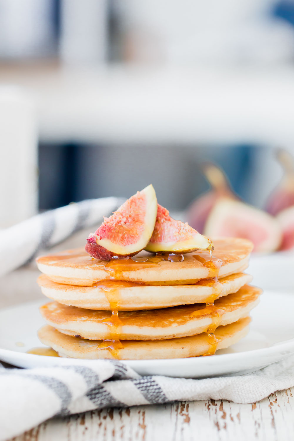 Easy Fluffy Fig Pancakes. So incredibly fluffy, tender and crisp in all the right places with a pile of fresh fruit and maple syrup for the ultimate breakfast.