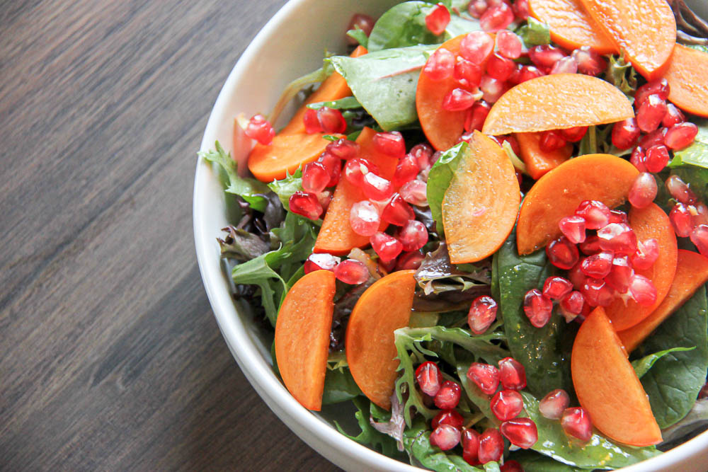 Persimmon Pomegranate Salad. A delicious Fall-inspired salad with all the vibrant and colorful parts of the season combined into one tasty salad.