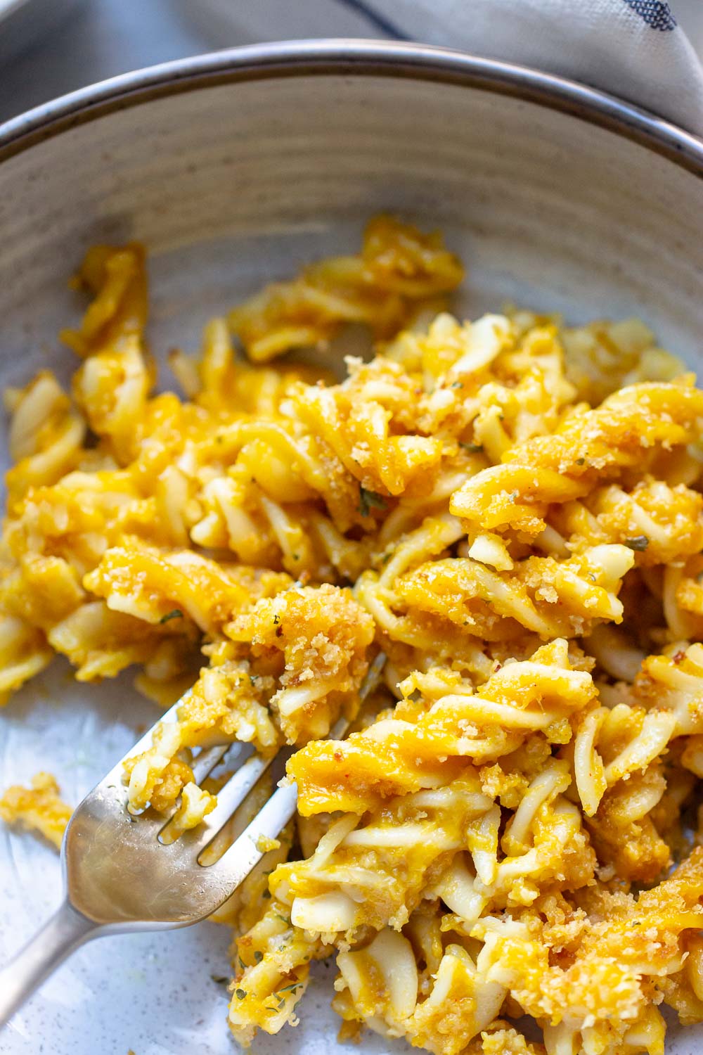 This easy pumpkin mac and cheese recipe is a must-try recipe! Pumpkin puree adds a taste of sweet and savory and creaminess to this cheesy macaroni. The perfect fall dinner!