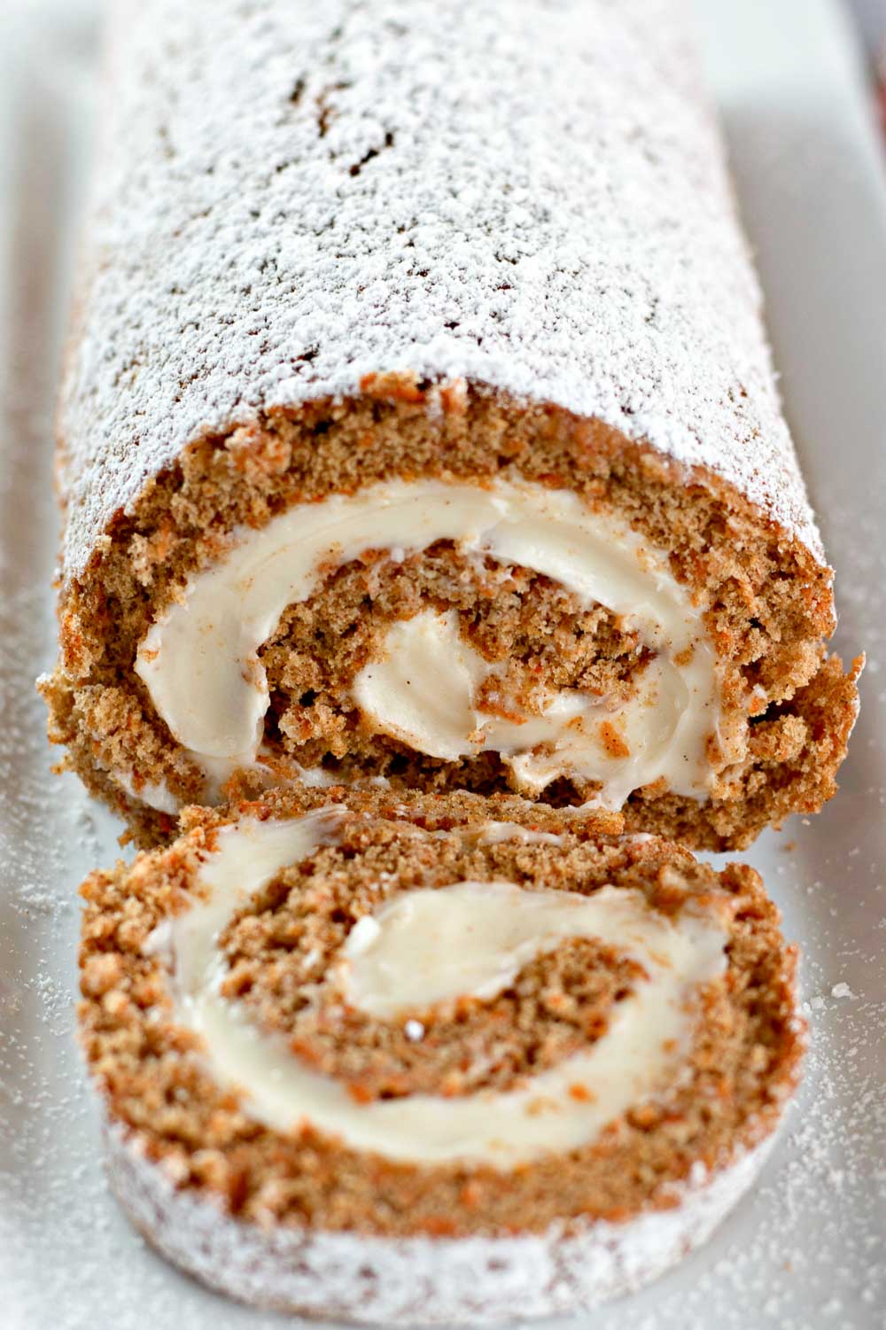 This Carrot Cake Roll is a must-try recipe. It is super-delicious, perfectly-spiced, moist, ultra-creamy, and makes a delicious dessert!